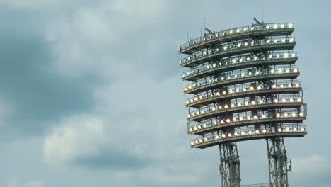 Stadium-lights-against-cloudy-sky-background