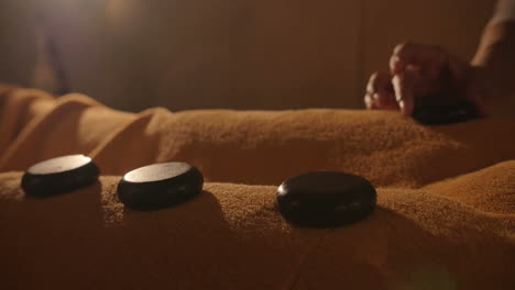 Masseur-Putting-Hot-Stones-on-the-Body