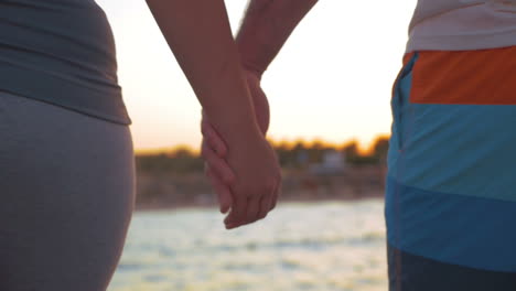 Couple-walking-outdoor-holding-hands