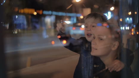 Mother-and-curious-son-in-night-city