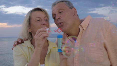 Senior-couple-blowing-bubbles-at-the-seaside