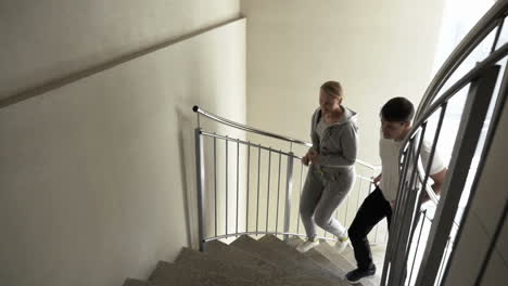 Couple-Running-Up-the-Spiral-Stairs