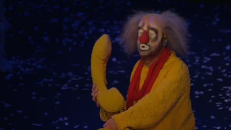 On-snow-show-of-Slava-Polunin-acts-clown-in-a-yellow-suit-and-talking-on-a-toy-telephone