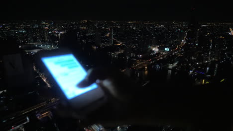 Girl-typing-message-on-cellphone-on-night-city-background