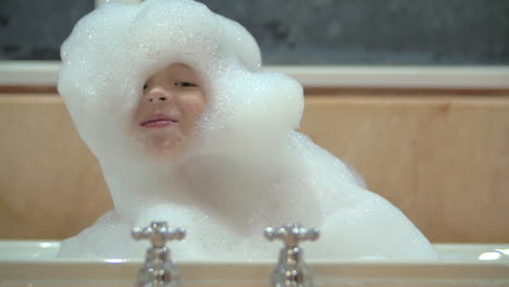 Happy-child-in-foam-taking-bath