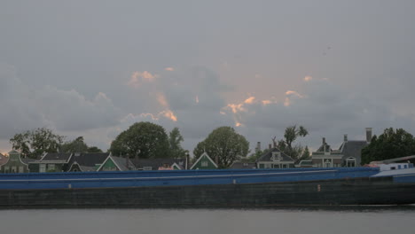 Barge-sailing-by-the-village-houses