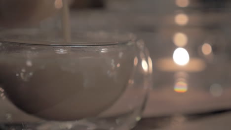 Pouring-masala-tea-into-a-glass-tea-bowl