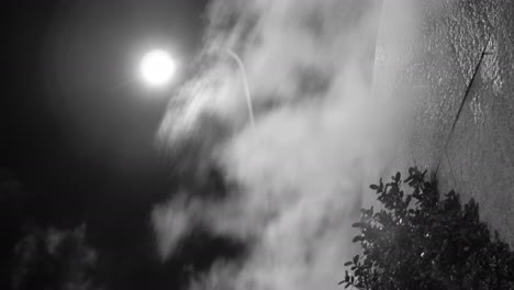 Steam-against-street-lantern-light-at-night-mystic-black-and-white-shot