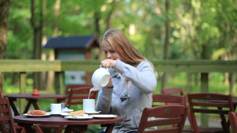 Young-woman-enjoying-a-pot-of-tea
