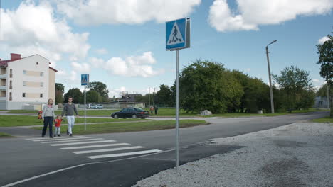 Family-of-three-crossing-the-road