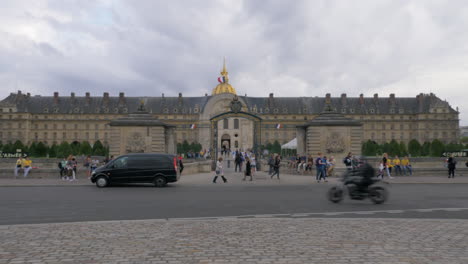 Entry-gates-of-Les-Invalides-with-people-walking-in-and-out-Paris-France