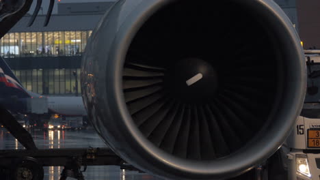 Engine-of-airplane-and-airport-terminal-in-background