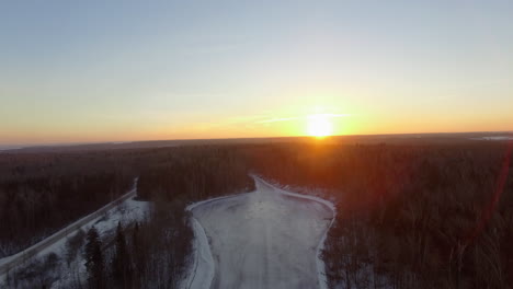 Aerial-landscape-of-sunrise-over-the-forest-in-winter