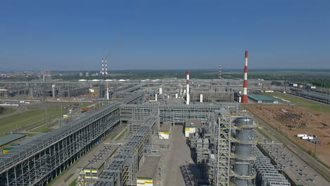 An-aerial-view-of-an-oil-refining-complex-against-bright-blue-sky