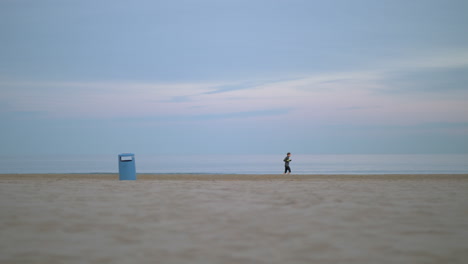 Jogger-running-beside-the-sea-on-a-cold-day