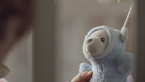 A-closeup-of-a-toy-bear-being-played-by-a-baby