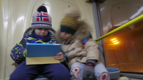 Timelapse-of-two-boys-with-tablet-computer-in-trolleybus