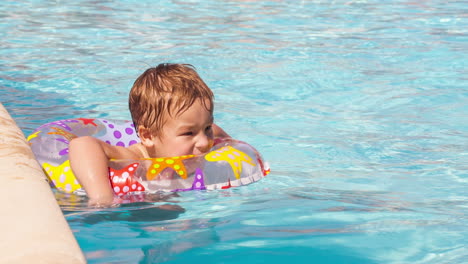 Boy-swimming-with-inflatable-ring