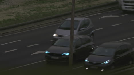 Transport-traffic-on-highway-in-the-evening-cars-with-lit-headlights
