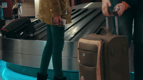 People-getting-luggage-on-conveyer-belt