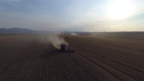 Aerial-View-of-Wheat-Harvest-Amidst-Dust-Clouds