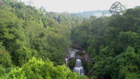 Aerial-View-of-Tropical-Waterfall-at-Sunrise