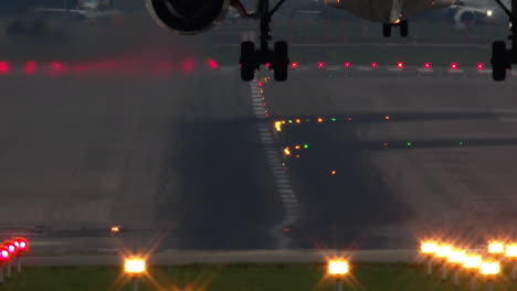 Slow-motion---airplane-landing-at-the-airport-in-the-evening