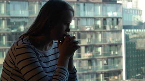 Lonely-sad-woman-against-modern-city-background