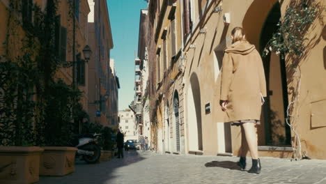 Woman-walking-along-old-narrow-street