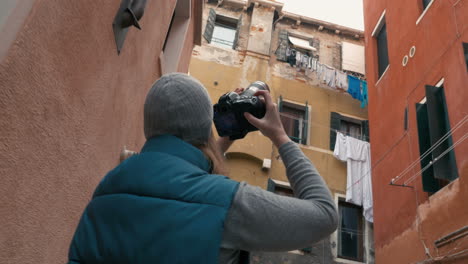 Female-photographer-taking-pictures-of-old-houses