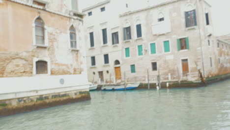 Man-walking-between-aged-houses-with-retro-camera