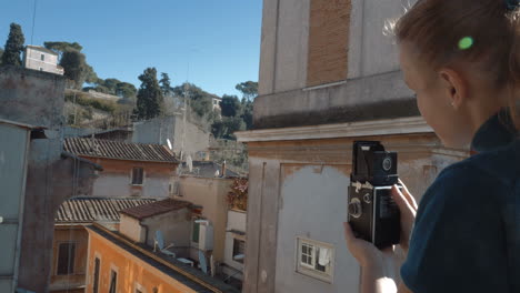 Woman-with-retro-camera-on-the-balcony