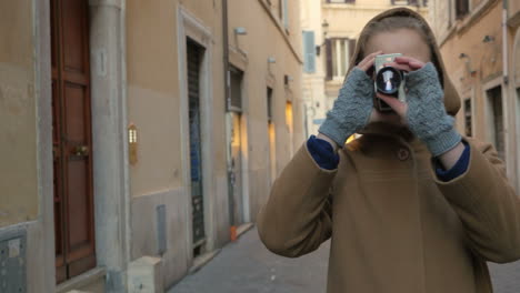 Woman-using-retro-video-camera-in-the-street