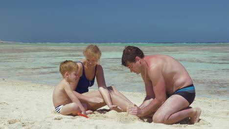 Young-Family-Building-Sand-Castle