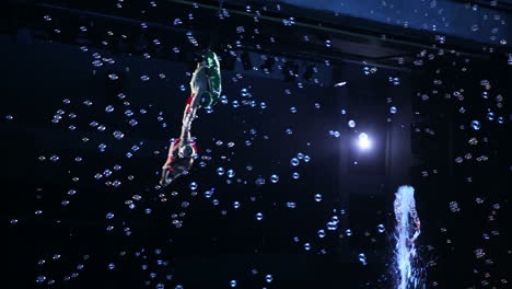 Aerial-gymnasts-performing-among-the-fountains-and-bubbles