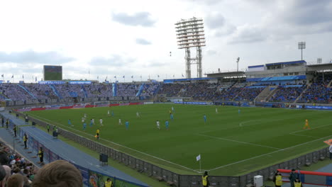 Football-match-before-crowded-stands-at-the-stadium