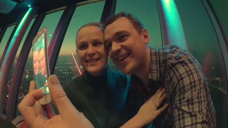 Loving-couple-making-selfie-with-cell-at-sky-deck