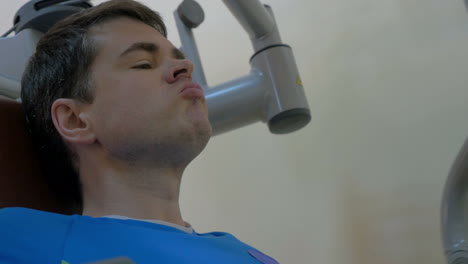 Young-man-doing-exercise-on-chest-press-machine