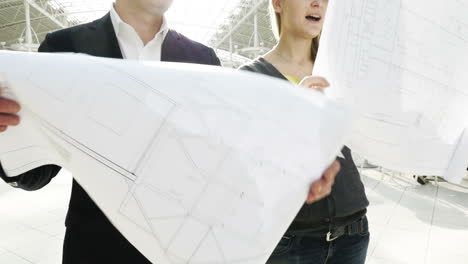 Man-and-woman-looking-at-construction-plans