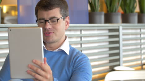 Man-Having-Video-Call-with-Tablet