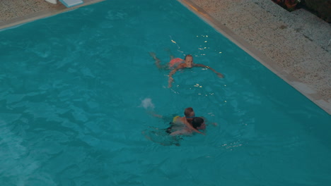 Parents-and-child-swimming-in-the-pool