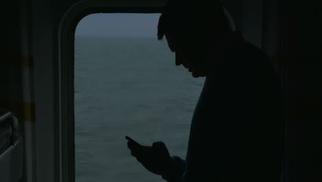 Adult-Man-With-Phone-On-The-Cruise-Ship