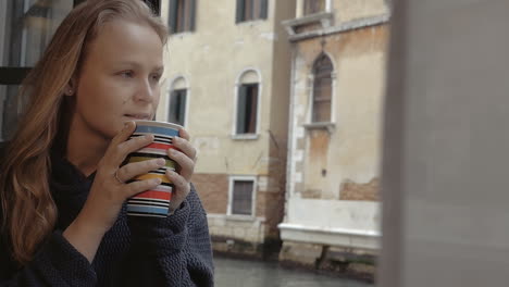 Woman-enjoying-hot-tea-and-outside-view