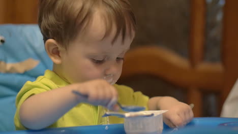 Little-Boy-in-High-Chair-with-Spoon