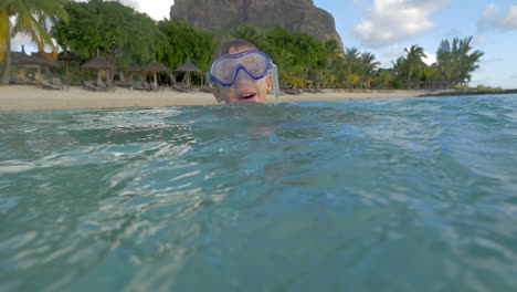 Slow-motion-view-of-small-boy-swimming-in-the-Indian-Ocean-in-the-snorkeling-mask-and-take-a-picture-Port-Louis-Mauritius-Island