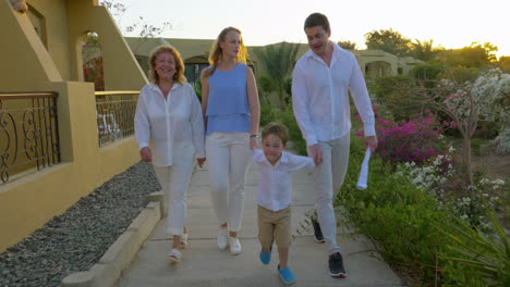 Family-walking-on-resort-area-in-the-evening