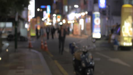 Street-with-illuminated-store-banners-at-night-in-Seoul-South-Korea