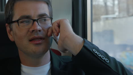 Businessman-Talking-on-the-Phone-in-Train