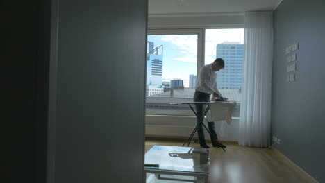 Man-ironing-the-clothes-at-home