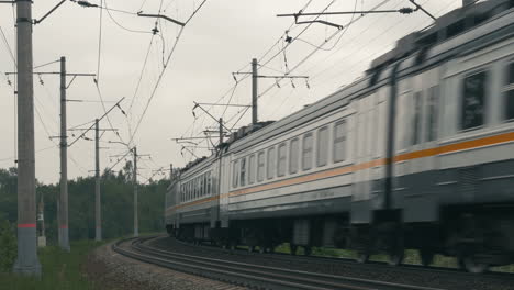 Suburban-Train-Moving-along-the-Railroad